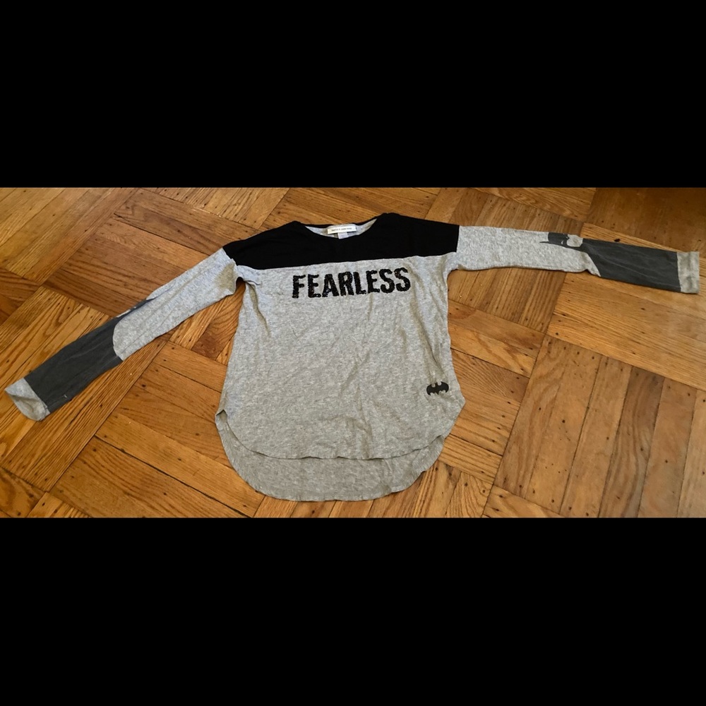 A fearless black T-shirt with Batman on the arms.